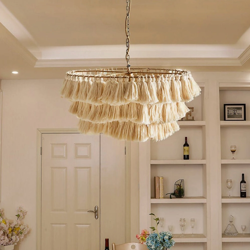 Eclectic multicolor bohemian tassel chandelier suspended above dining table with cultural textiles