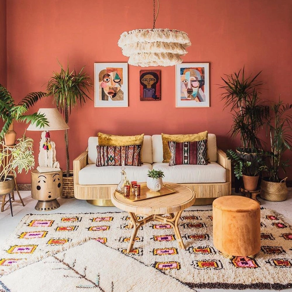 Cream tiered tassel chandelier complementing boho wall art, woven rugs in warm living room setting