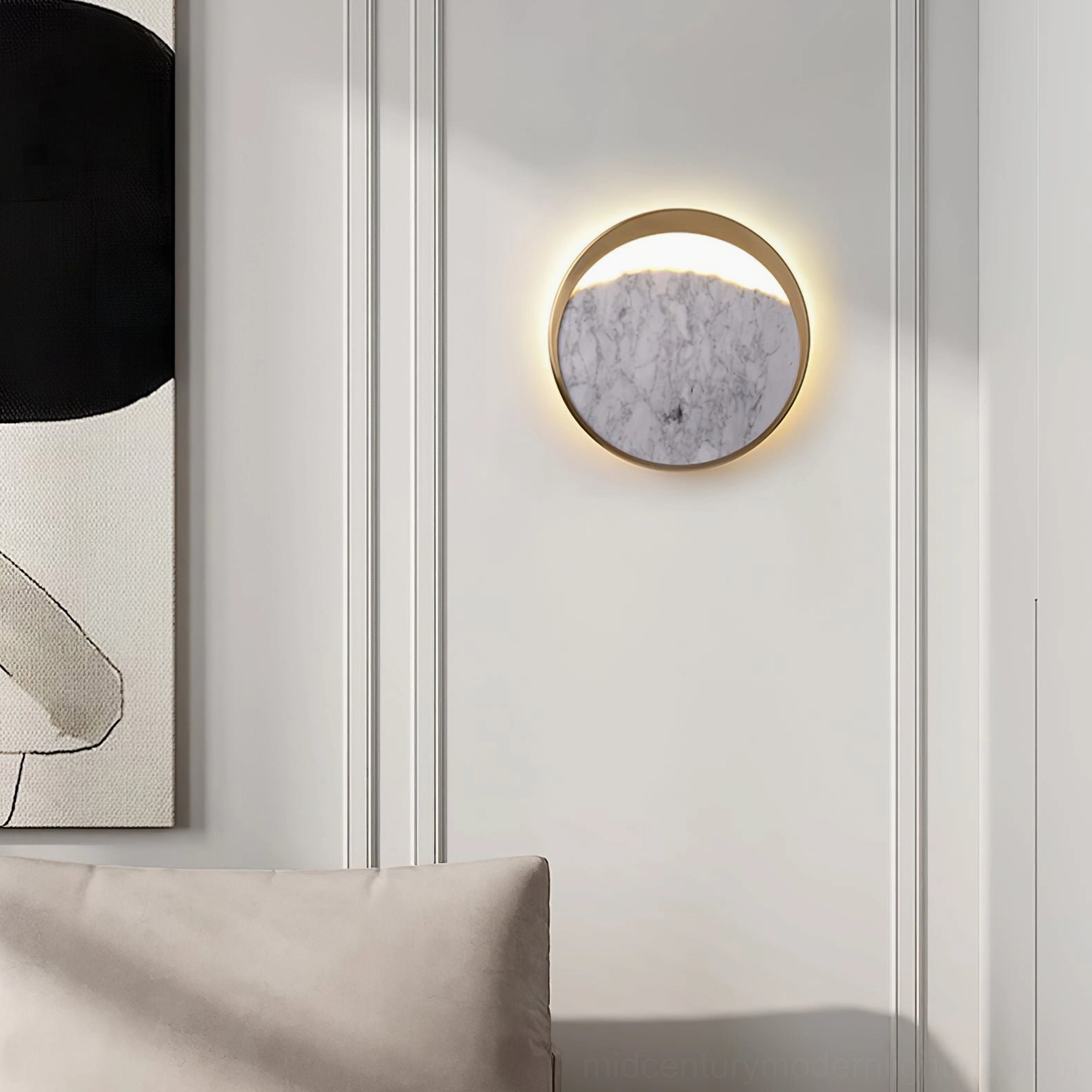 Illuminated Eclipse marble wall lamp creating warm ambient light in minimalist living room with sofa