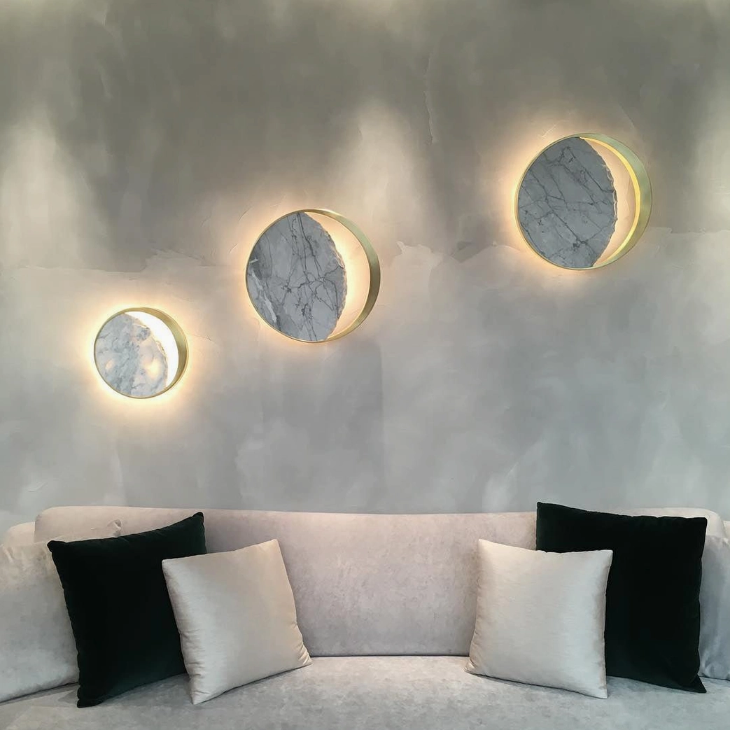 Eclipse marble wall lamp with natural wood furniture and linen textiles material pairing