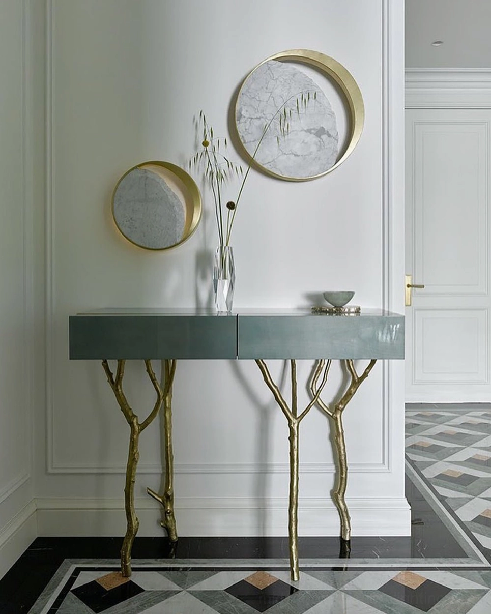 Eclipse marble wall lamp paired with jewel tone emerald green wall in luxury home interior