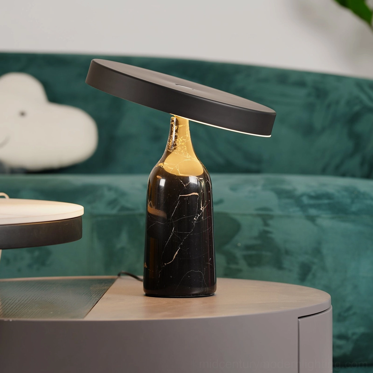 Black Eddy marble table lamp with rotating shade on TV console with books and home decor