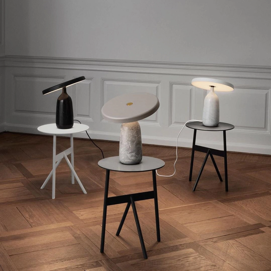Black Eddy rotating lamp with marble base and gold accent neck, minimalist interior design