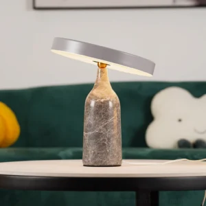 Modern Eddy marble table lamp in living room with teal sofa, grey shade on round side table