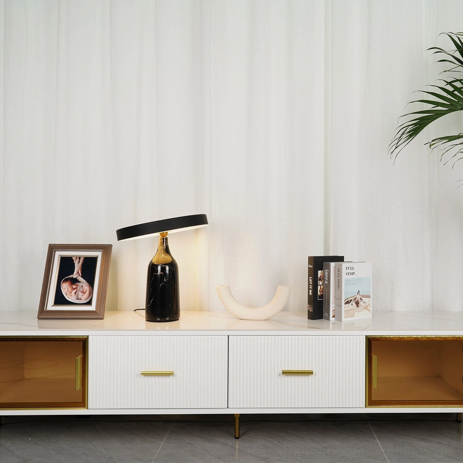 Multiple Eddy mid-century modern table lamps in three color schemes on wood-floored living room