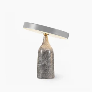 Eddy modern rotating disc table lamp with grey metal shade and grey marble base, front view studio lighting