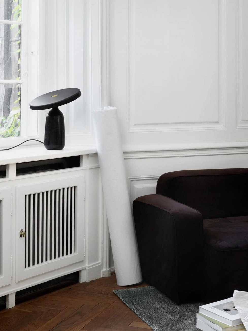 White Eddy table lamp with marble base on wooden shelf corner, minimalist home decor