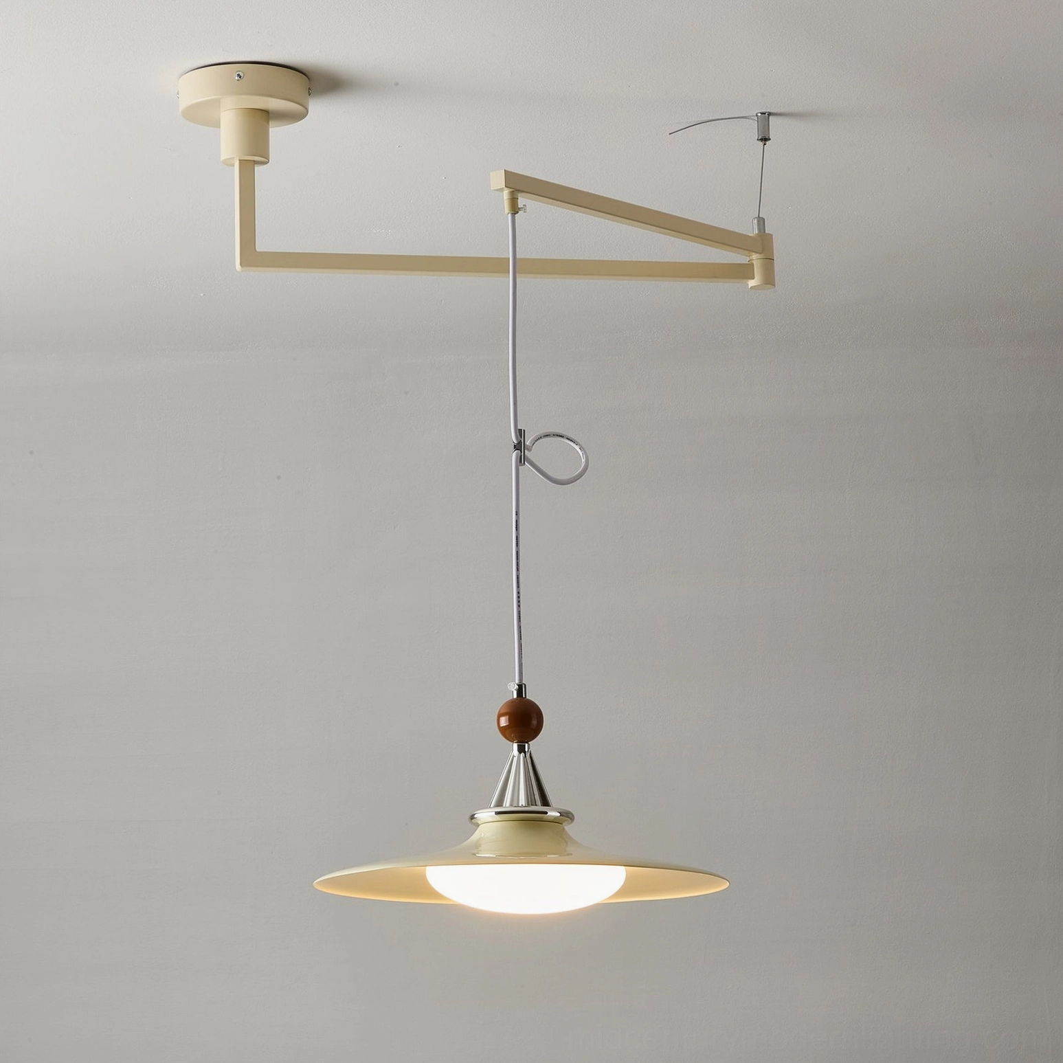 Mid-century modern swing arm pendant light highlighting adjustable arm articulation and positioning flexibility for directional lighting