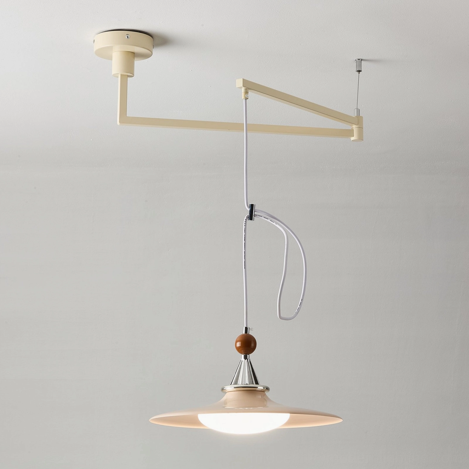 Cream swing arm pendant lamp with light beige shade and adjustable metal frame, showcasing color tone and design proportions in neutral background