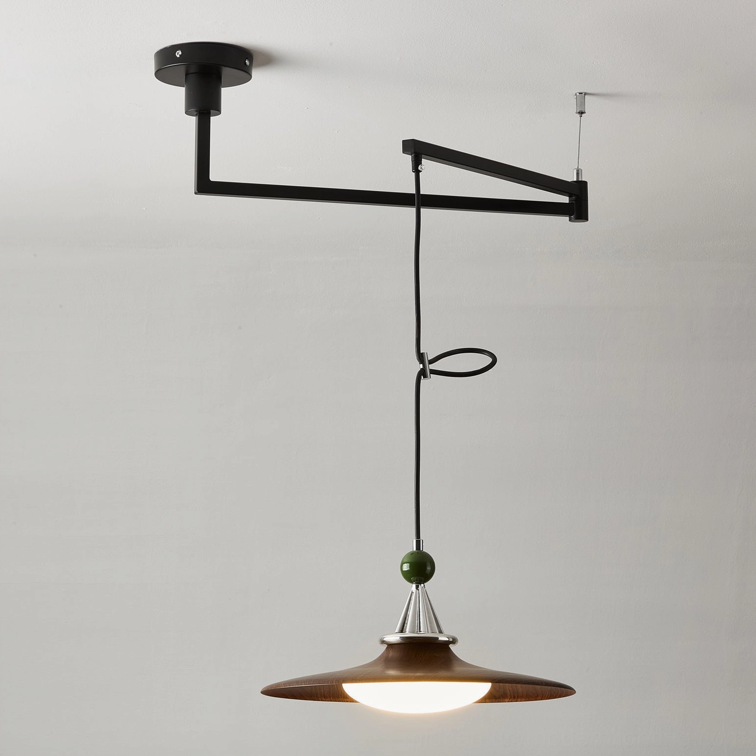 Pink Eden swing arm pendant light with metal frame and acrylic shade, detailed studio view of retro color finish