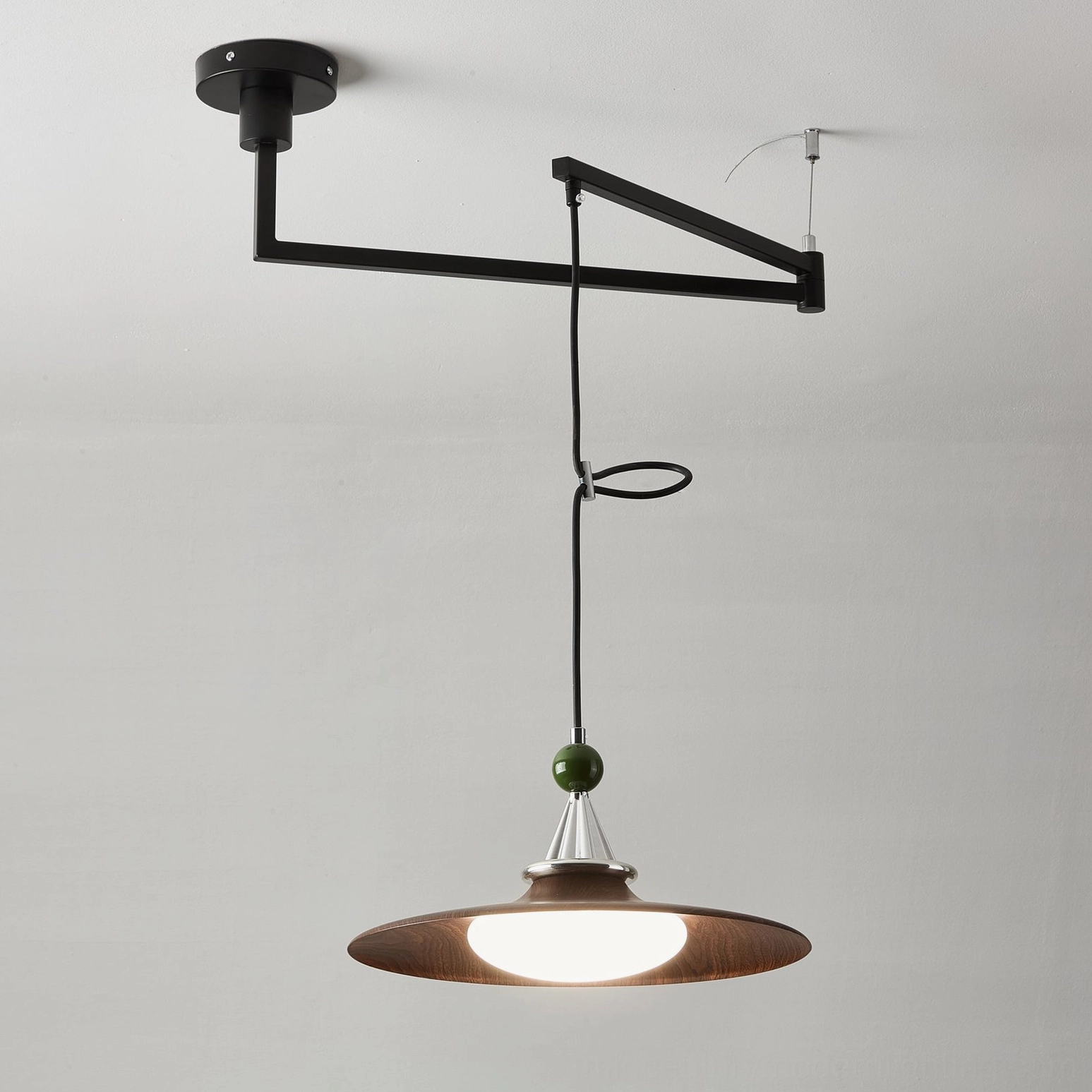 Swing arm pendant light with cream finish in contemporary interior setting demonstrating versatile design compatibility
