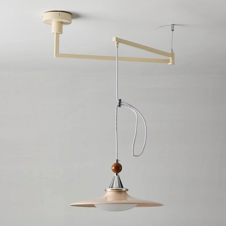 Eden swing arm pendant lamp in pink color with saucer-style shade and green spherical accent, showcasing vibrant finish option