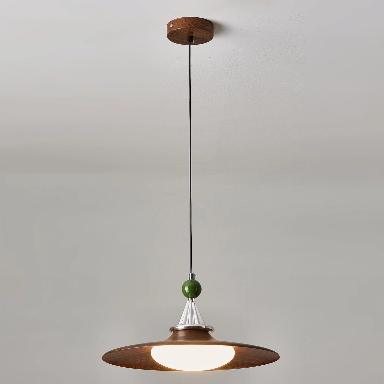 Dark walnut mid-century pendant light with frosted diffuser glowing warmly