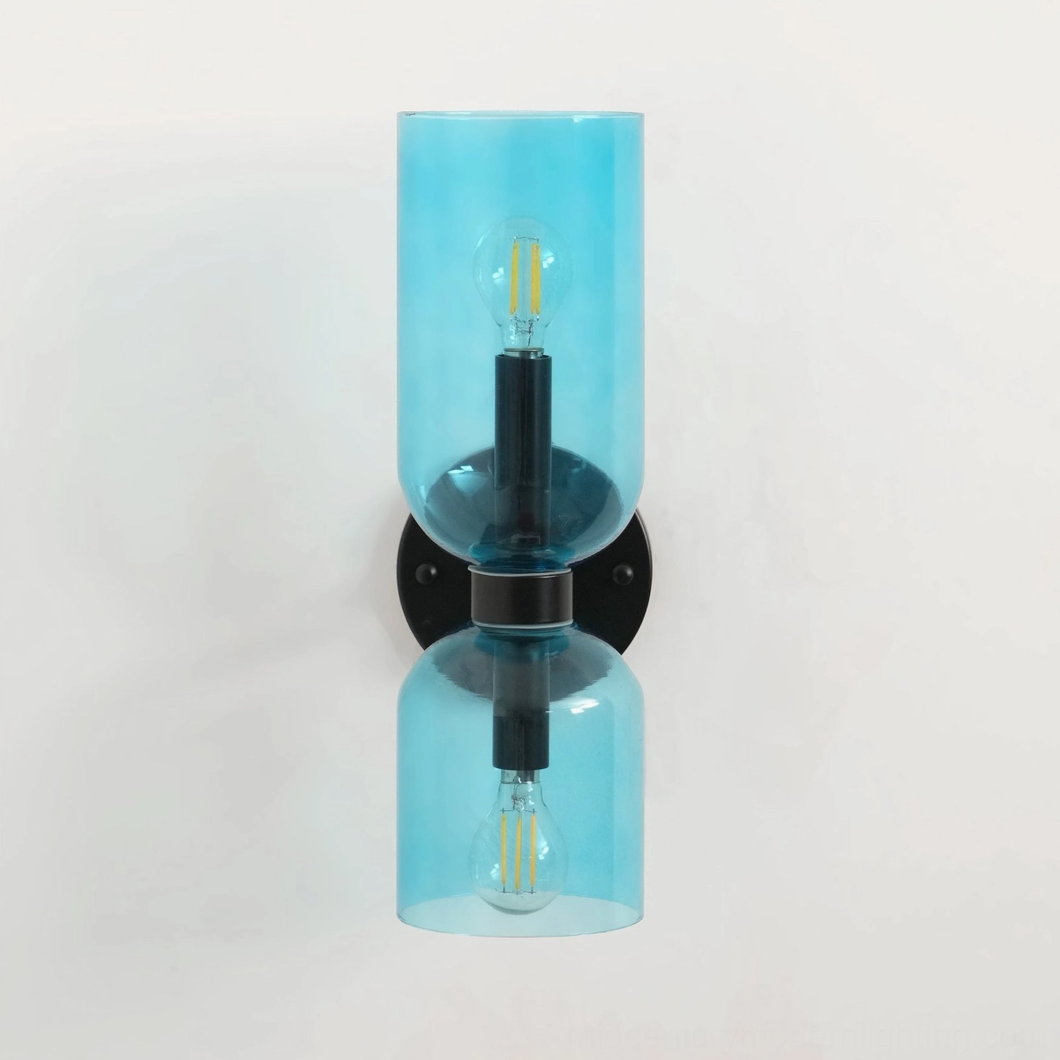 Architectural glass sconce with polished gold frame and cylindrical blown glass form
