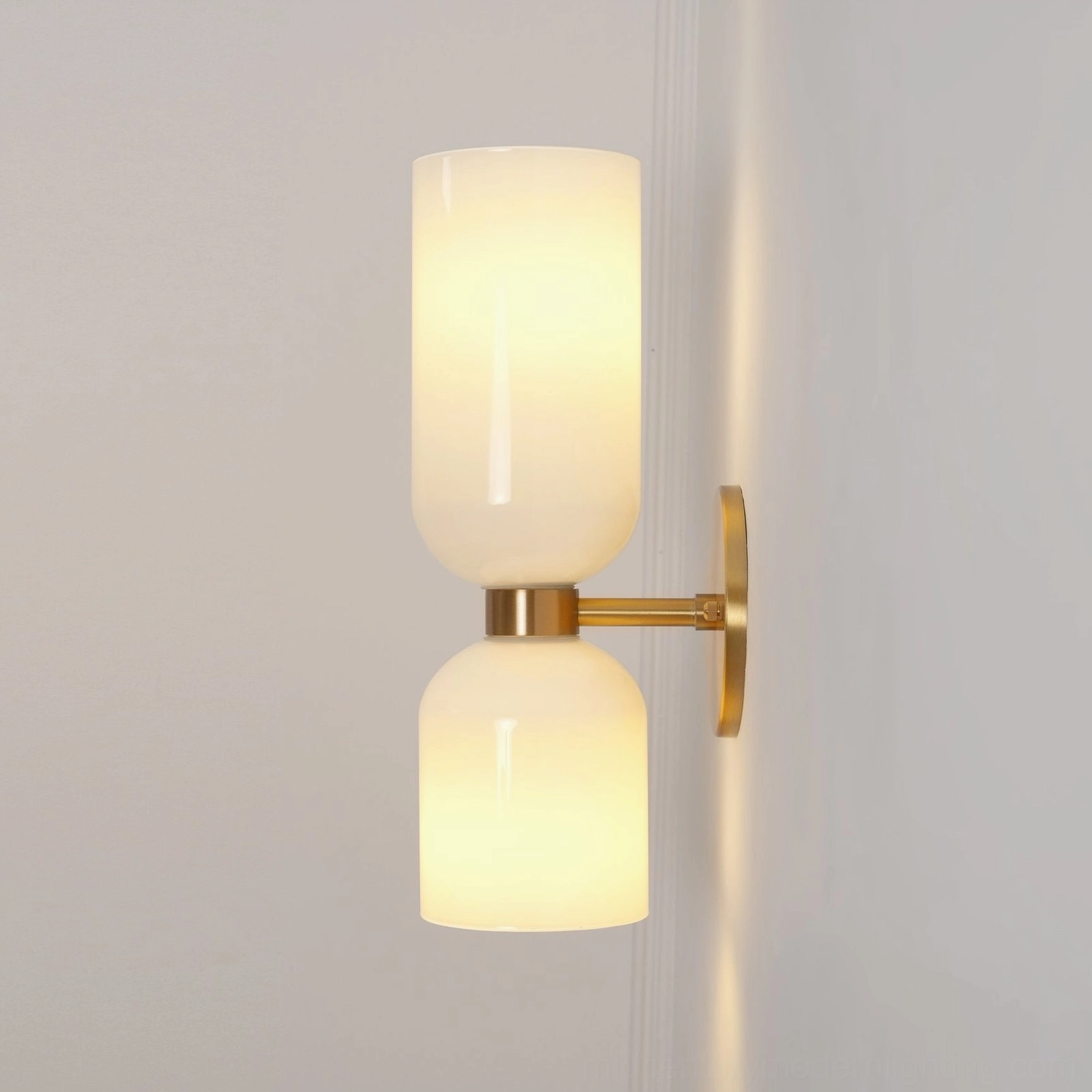 Artistic blown glass wall lamp showcasing transparent form with warm metal frame mounting