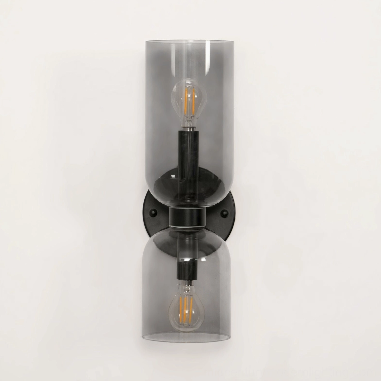 Hand-blown glass wall sconce showing cylindrical form with matte black frame contemporary style