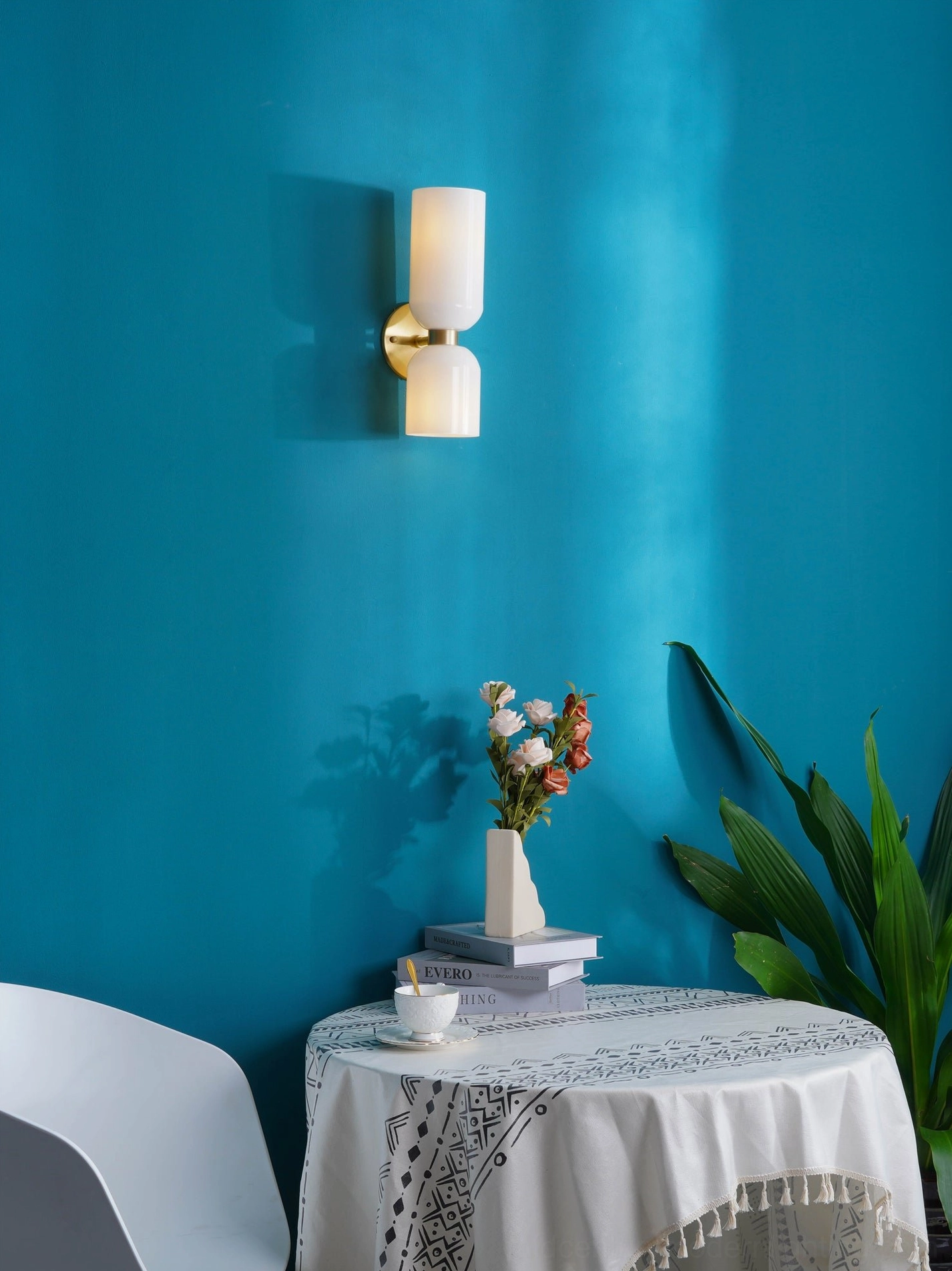 Modern wall sconce with transparent glass vessel and architectural metal frame in residential interior