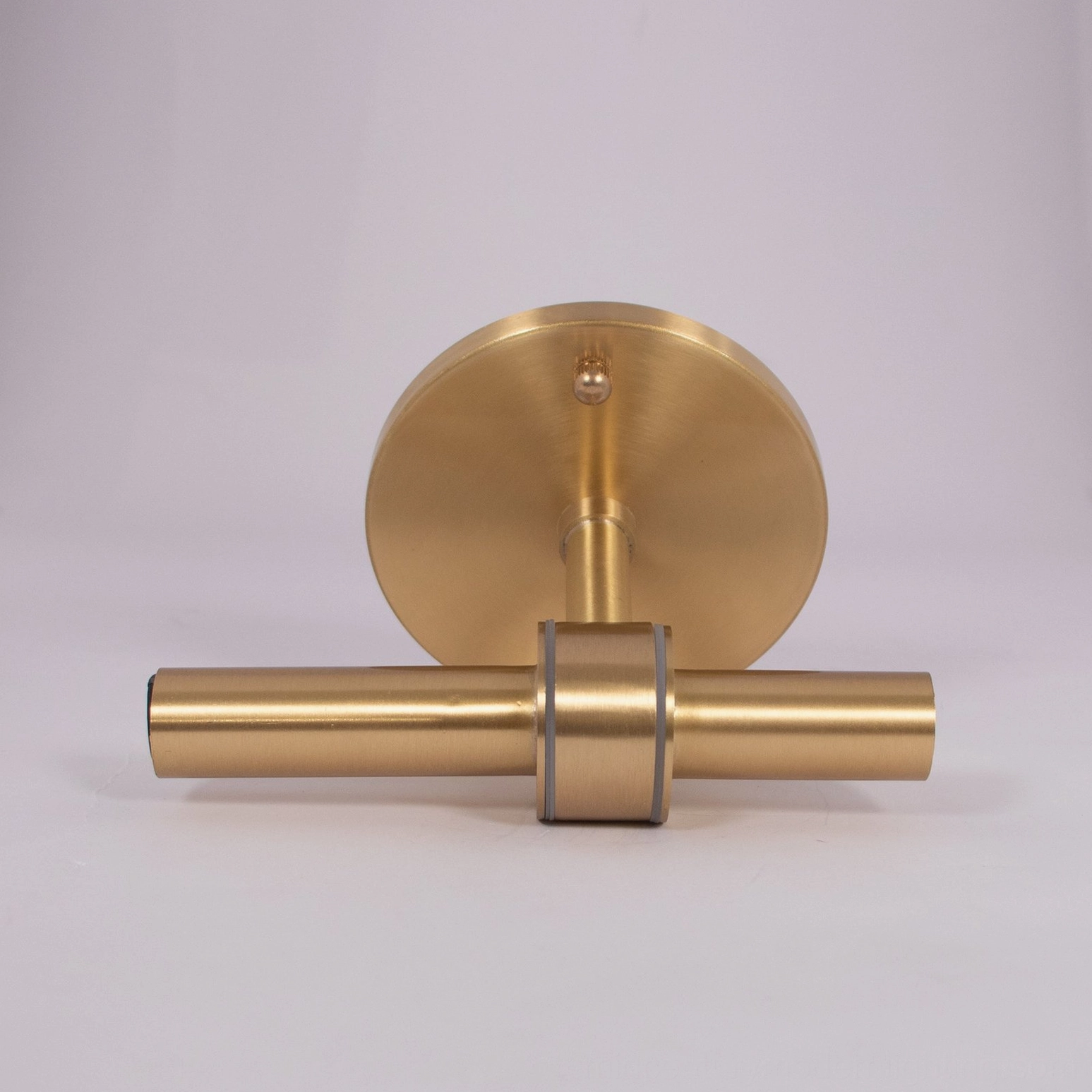 Contemporary glass sconce mounted on wall showing architectural dialogue between glass form and metal frame
