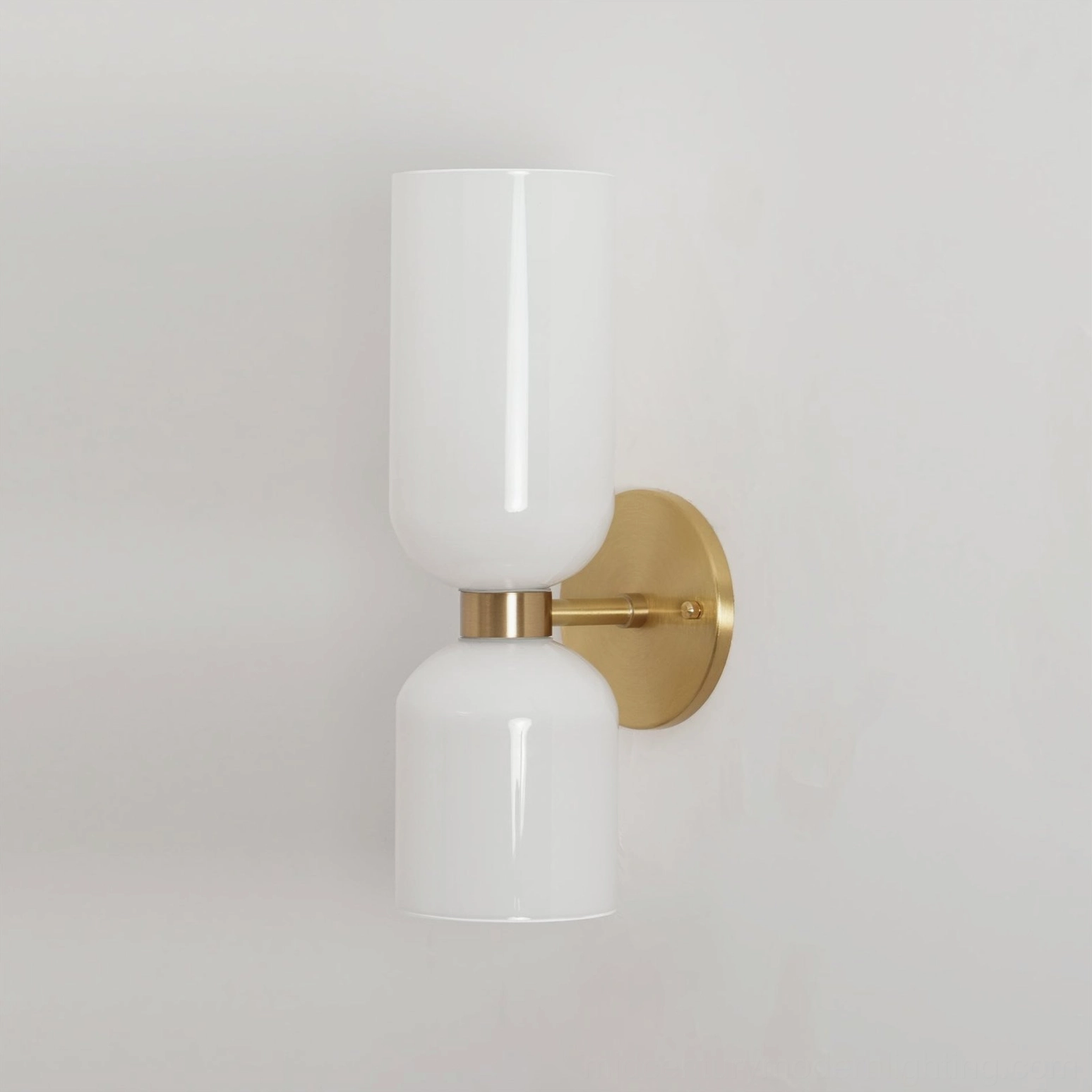 Contemporary minimalist sconce with smoked glass shade and polished gold hardware