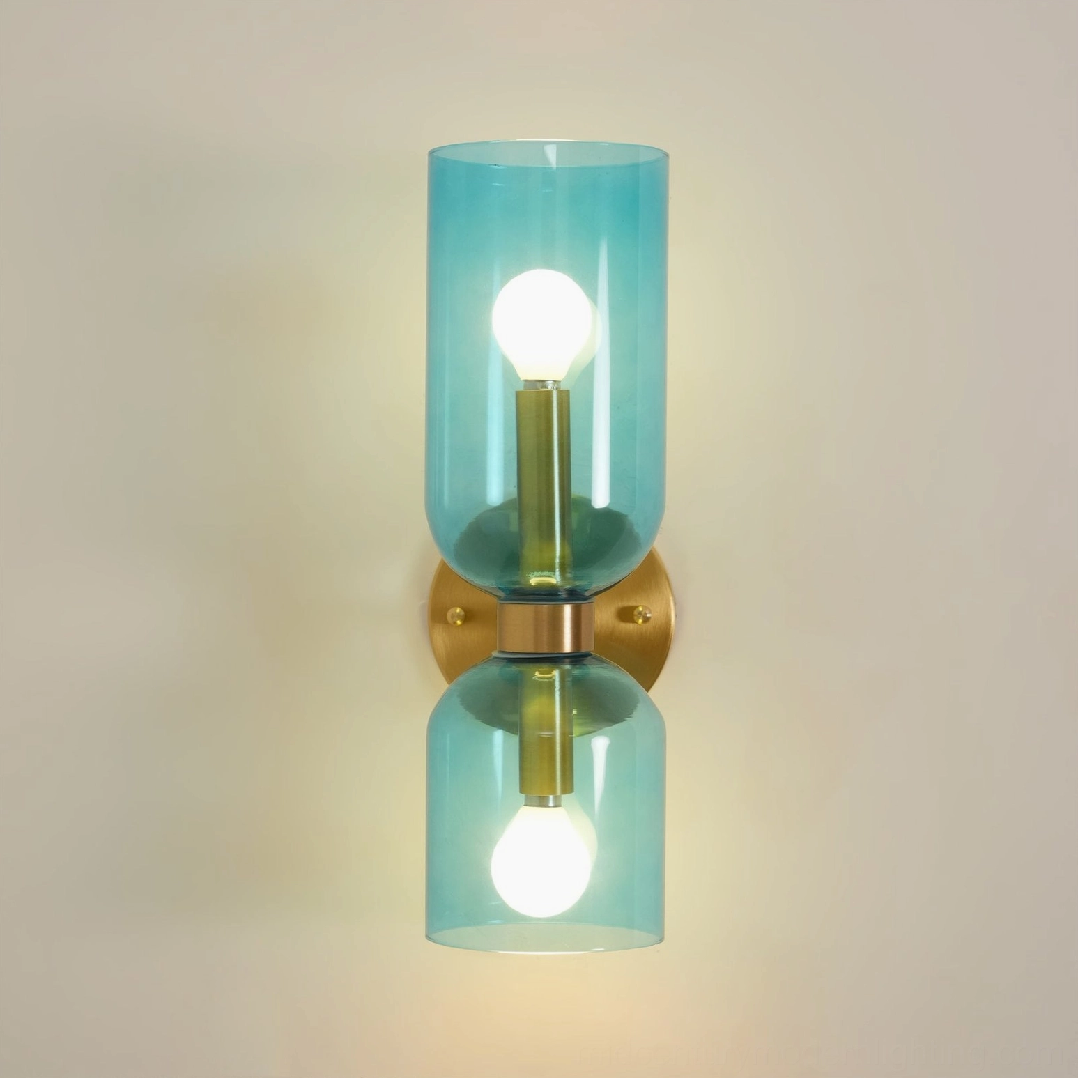 Designer sconce with hand-blown glass shade creating ethereal light effect on interior wall