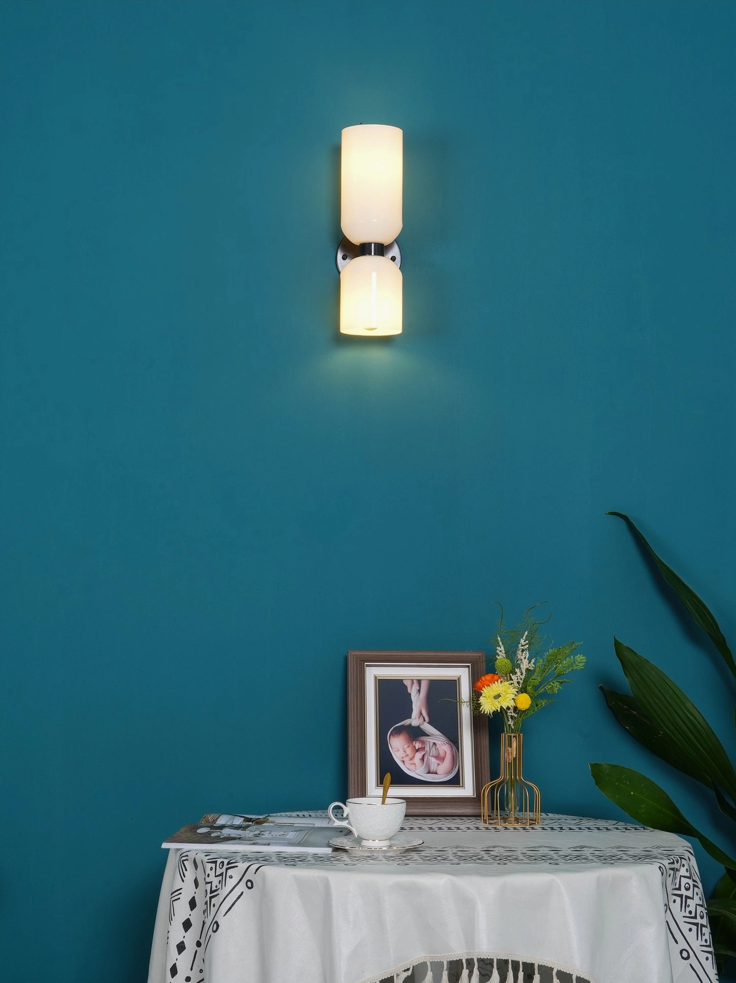 Contemporary glass wall lamp showing frosted glass shade with warm light diffusion and metal hardware