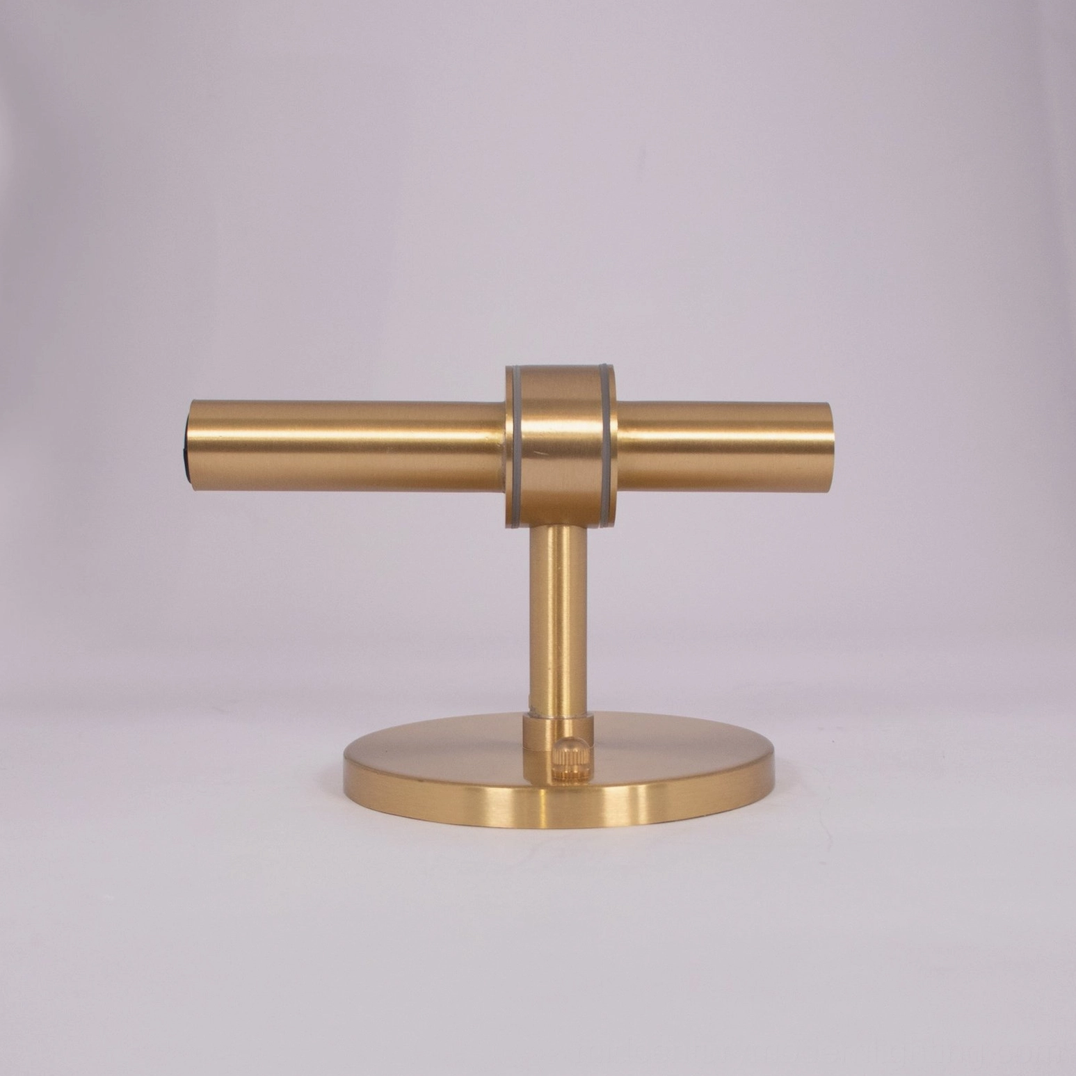 Modern minimalist wall sconce featuring hand-blown glass and refined geometric metal base