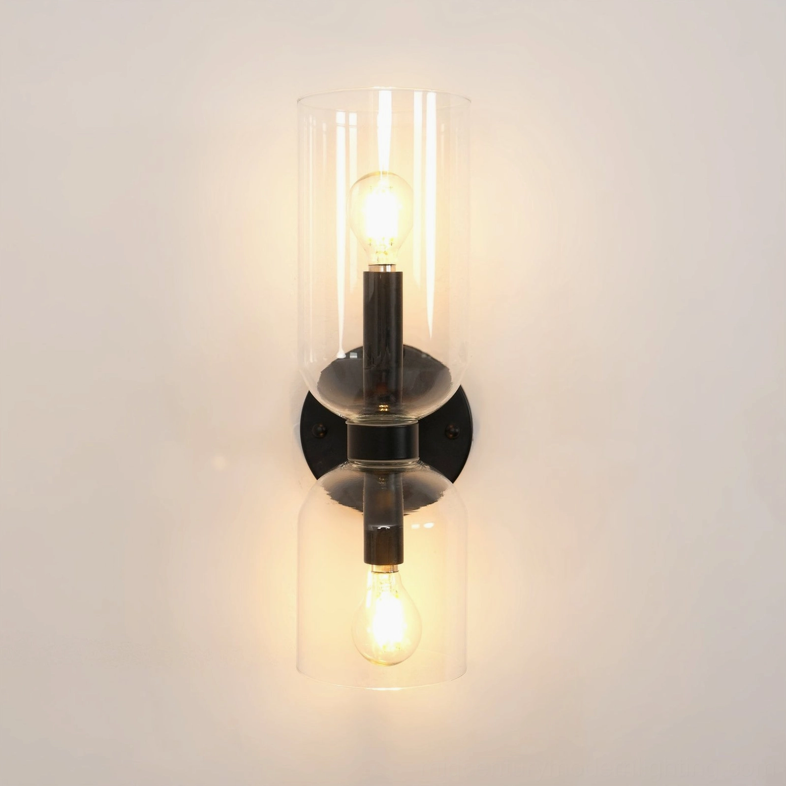 Minimalist blown glass sconce with frosted shade and refined brass hardware in studio setting