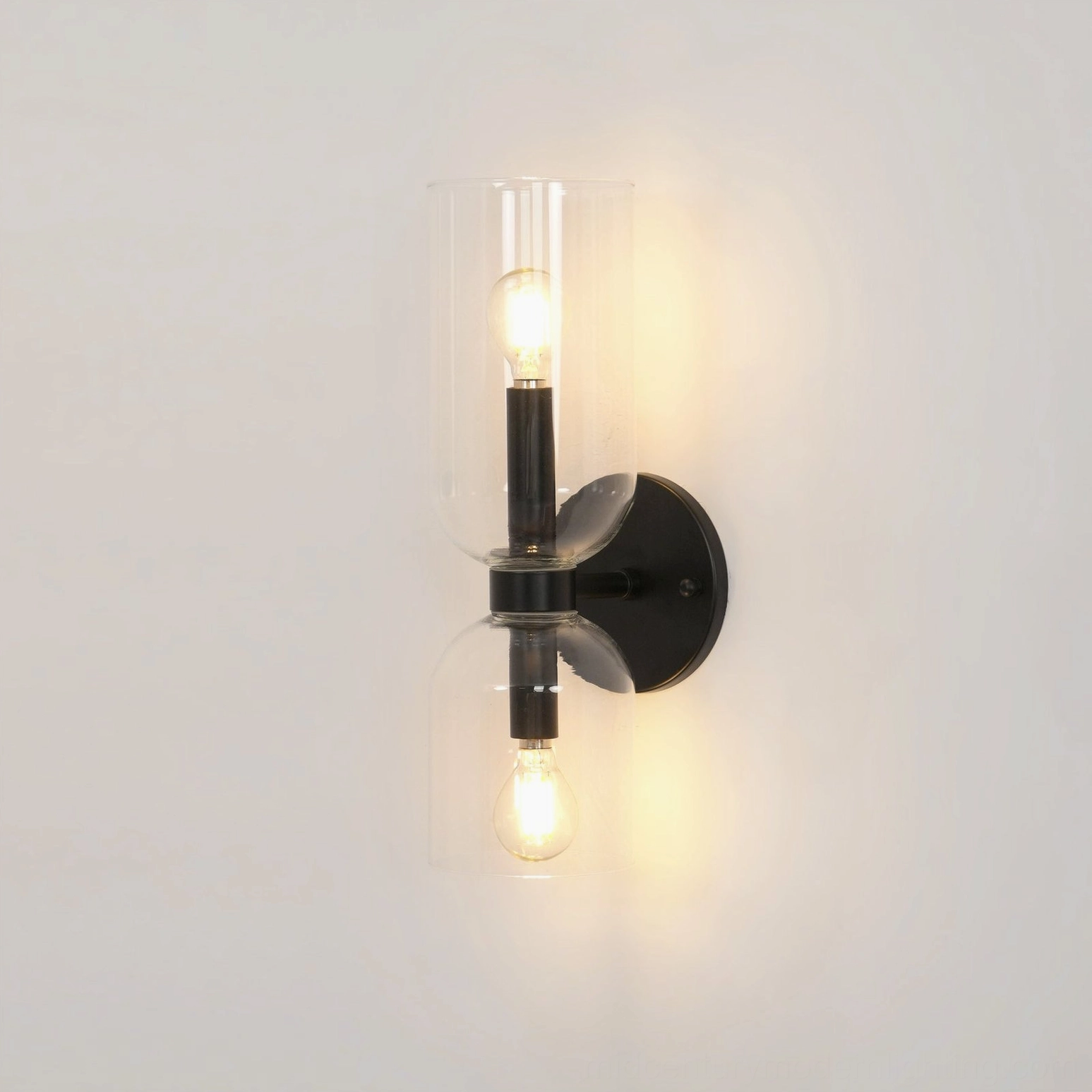 Minimalist wall sconce with transparent glass vessel and polished metal frame architecture