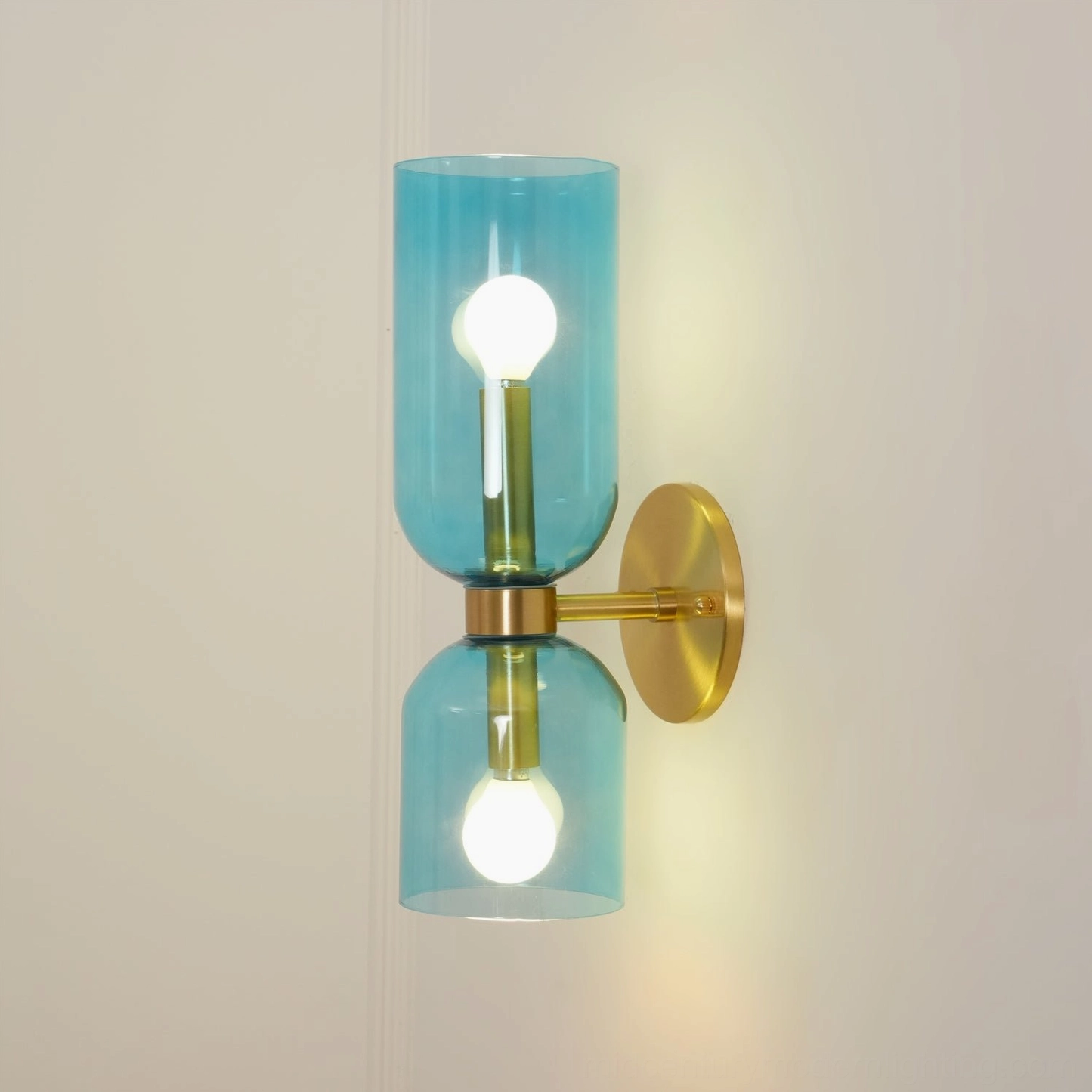 Edie wall sconce featuring frosted glass with architectural metal base in minimalist design