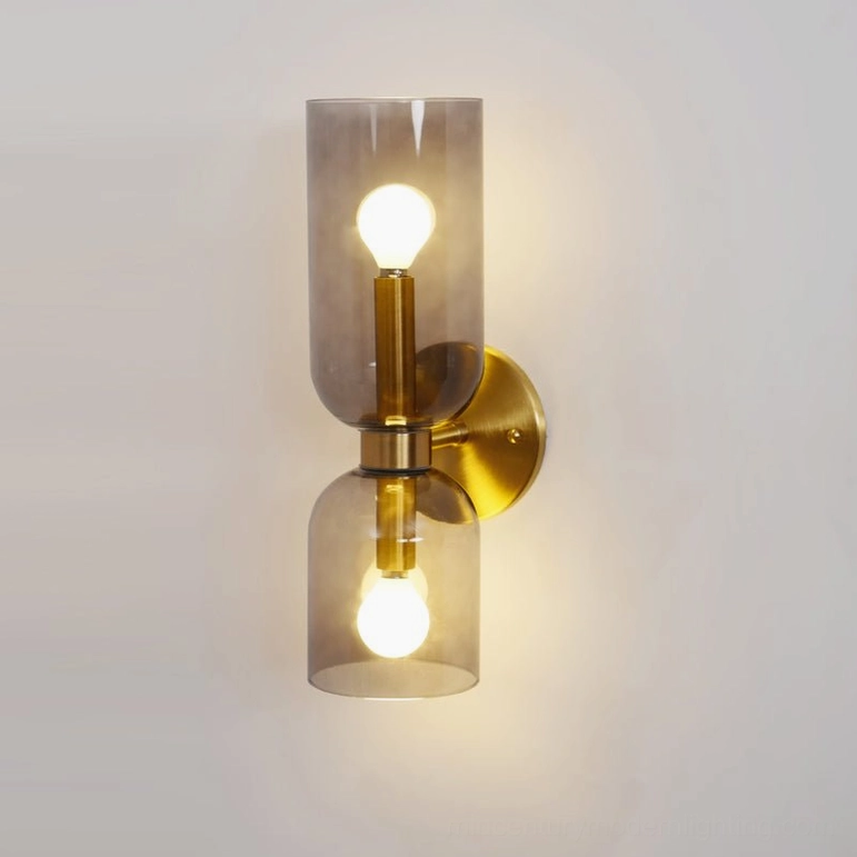 Hand-blown glass sconce featuring smoked grey shade with polished gold metal base and frame