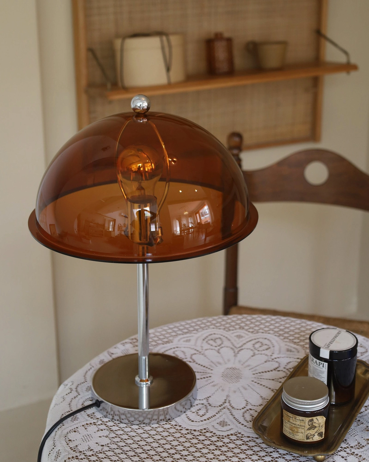 Edinburgh table lamp with brown translucent shade on dining room side table, three-quarter view