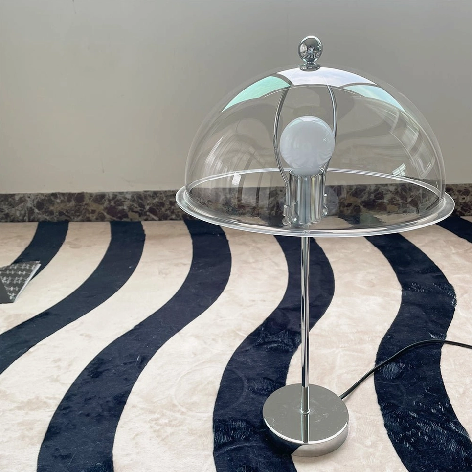 Edinburgh table lamp with clear acrylic dome on striped rug, front flat product shot showing transparency