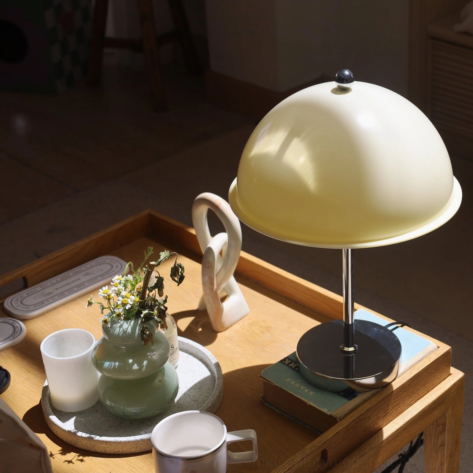 Edinburgh table lamp with cream white acrylic shade on wooden side table, three-quarter angled view