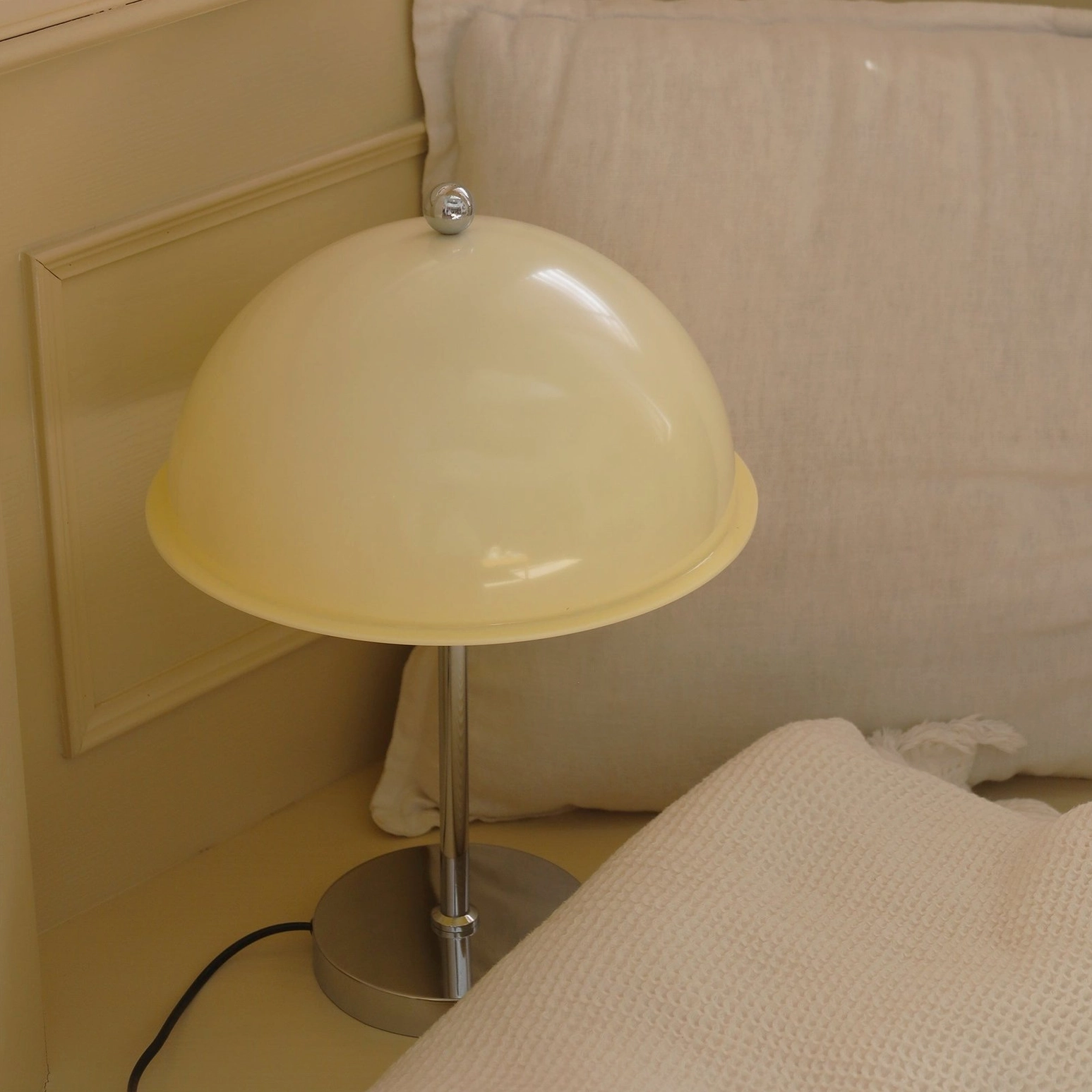 Edinburgh table lamp green sage acrylic shade glowing with warm light in contemporary interior