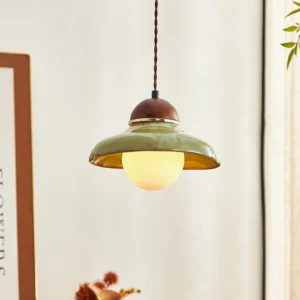 Edmund pendant light suspended and illuminated, showing warm glow through frosted glass diffuser in modern interior