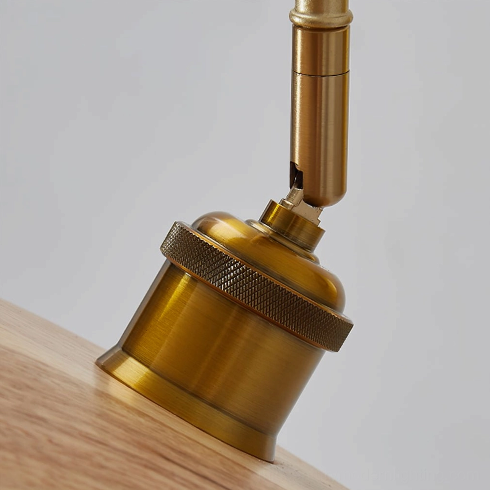 Close-up of Edmund wall lamp brass knurled metal joint and hardware detail on wood background