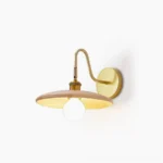 Edmund mid-century wall sconce with natural wood body and brass gold hardware, front view on white background