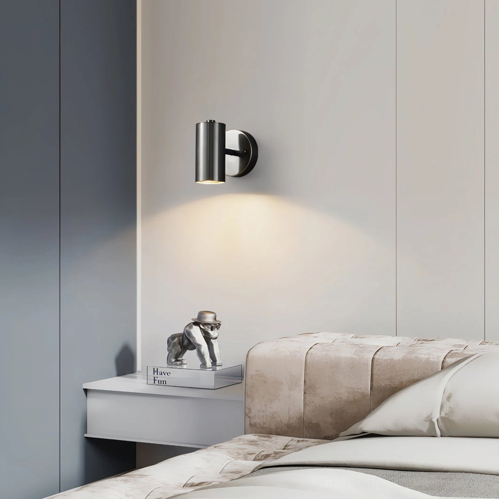 Eduard matte black wall sconce positioned as bedside reading light in modern minimalist bedroom