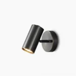Eduard matte black adjustable wall sconce with 90-degree swivel head in minimalist studio setting