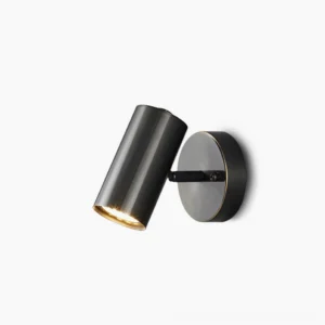 Eduard matte black adjustable wall sconce with 90-degree swivel head in minimalist studio setting