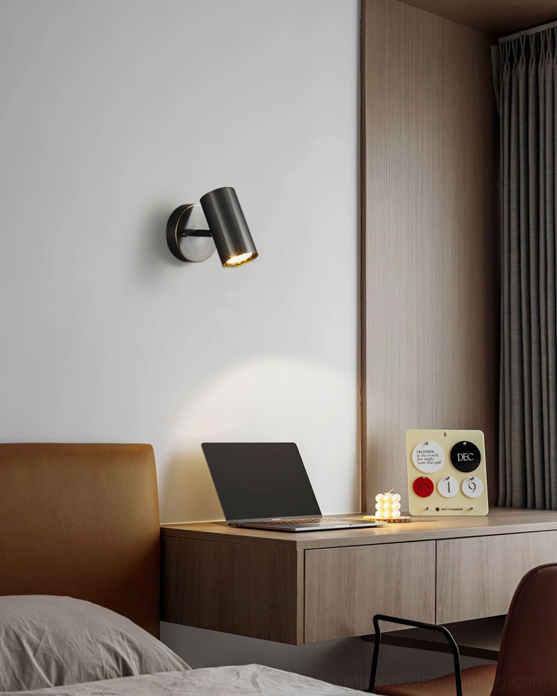 Eduard adjustable wall sconce positioned to spotlight artwork and wall displays