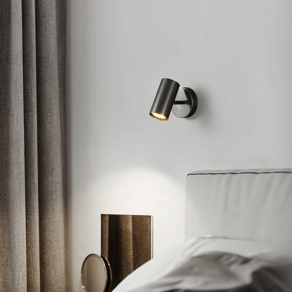 Eduard dark metal wall sconce with warm ambient lighting beside gray bedroom curtains