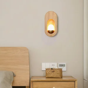 Egg wall lamp mounted above wooden nightstand in bedroom, warm ambient lighting in cozy bedroom setting