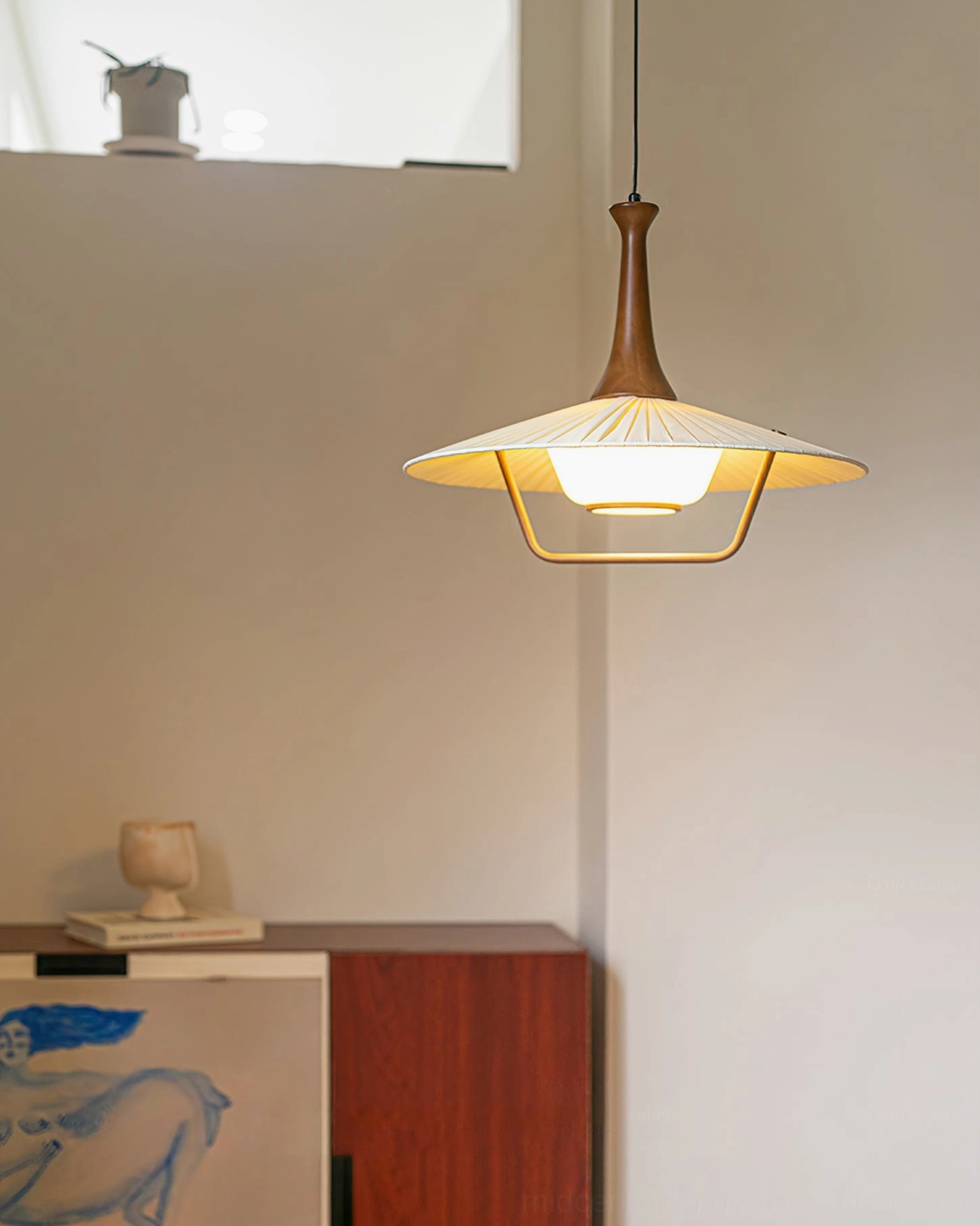 Eikon hanging pendant lamp in minimalist home corner, artistic cabinet styling mid-century modern