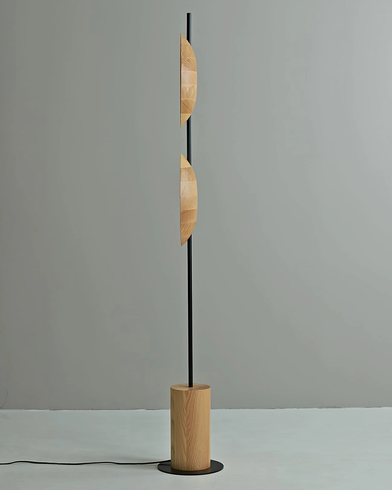 Side profile of Eine floor lamp showing natural wood discs and slender metal vertical pole