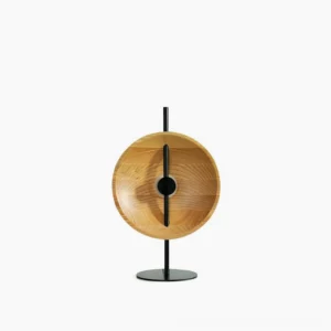 Eine mid-century modern wood disc table lamp with black metal base, minimalist design with geometric cutout, frontal view on white background