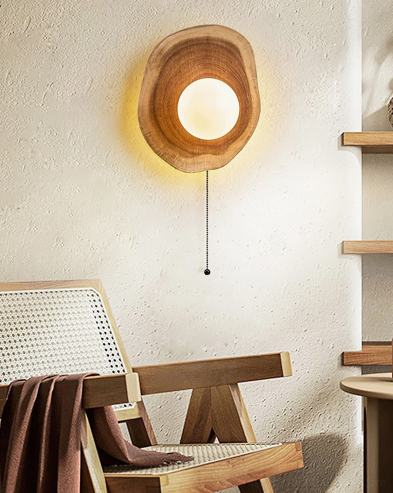 Eivor wooden wall lamp in living area with rattan chair showcasing natural wood tone and rustic Scandinavian home décor compatibility