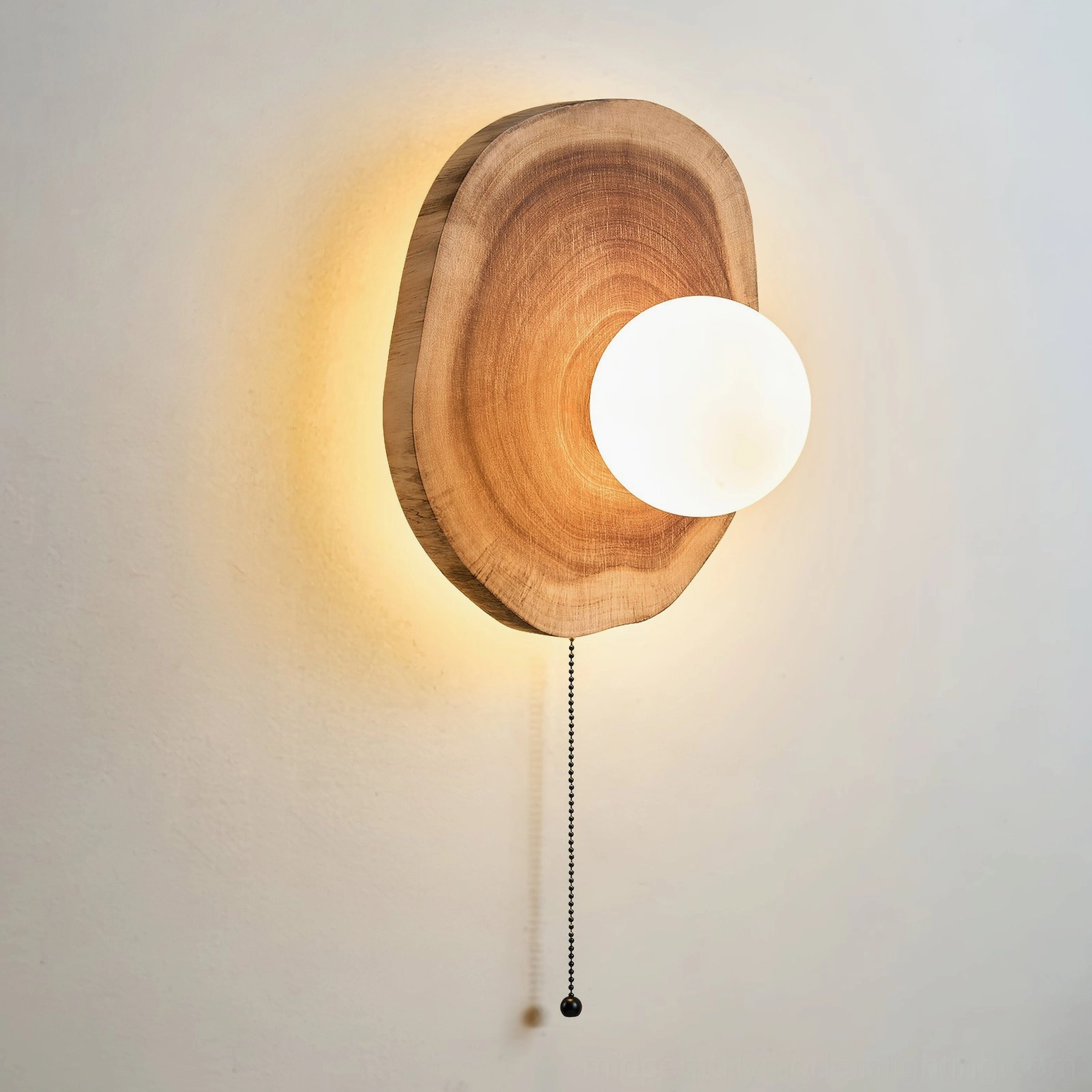 Side profile of Eivor wall sconce with offset frosted glass globe highlighting unique asymmetrical wooden frame construction and minimalist design