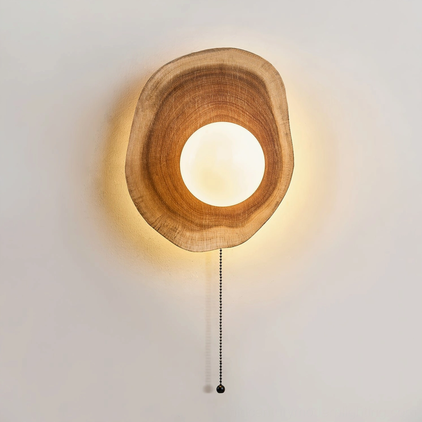 Close-up frontal view of Eivor wooden wall lamp showcasing smooth natural wood grain texture and frosted glass sphere detail against neutral background