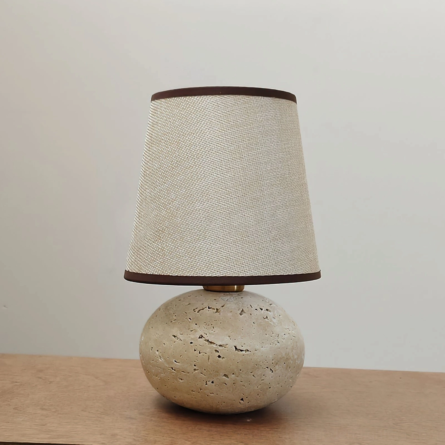 Elba mid-century modern travertine table lamp overall product shot, showing proportional design from base to linen shade with warm natural lighting